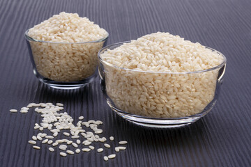 glass bowls with white rice on dark wooden table