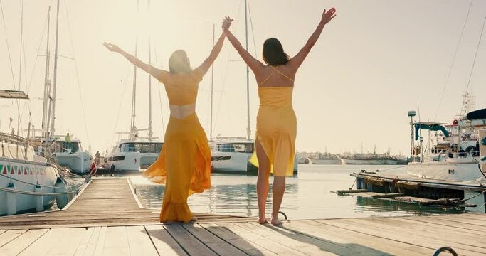 Back, happy and women holding hands at a harbor for vacation, relax and bonding. Beach, travel and friends or people with care, love and trust at the ocean or a port in summer for a holiday together