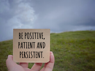 Motivational and inspirational wording. Be Positive, Patient And Persistent written on a notepad....