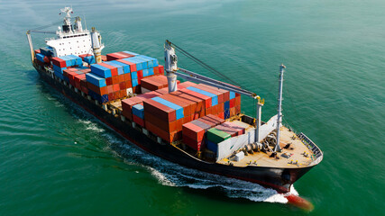 Fototapeta premium cargo logistic container ship sailing full speed in green sea to import export goods and distributing products to dealer and consumers worldwide, by container ship Transport, aerial view