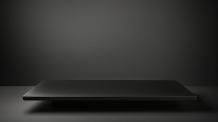 Photo of a minimalist black square table on a sleek black background