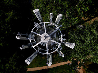 transmission of various drum shapes on a telecommunications tower. colors white and khaki green...