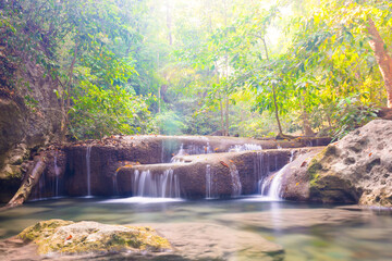 Waterfall in tropical landscape, green trees in wild jungle forest