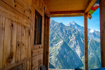 A creative Himachal Pradesh homestay balcony view in Kinner Kailash Mountain range, capturing a scenic mountain peak. Travel theme.