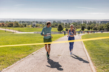 senior mature people marathon - reach the finish line - fellow mature athletes runners