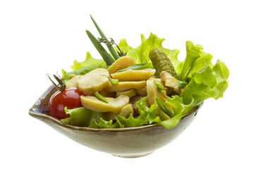 Marinated mushrooms in white saucer isolated on white