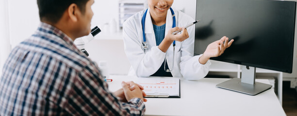 Naklejka premium Doctor consulting with patient discussing something and Presenting results on report, Medicine and health care concept.