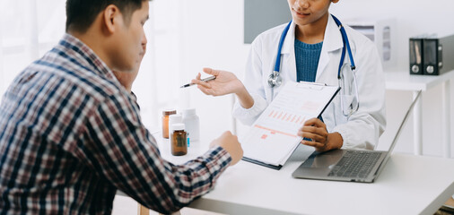 The African doctor holds the patient’s. hand Healthcare and medical concept. In hospital..