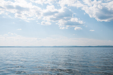 Seascape view of lake Uvildy in summer with cloudy blue sky above it, South Ural, Russian Federation