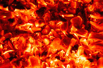 Smoldering charcoal in a bonfire, background texture