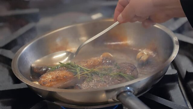 The chef prepares delicious meals by pouring the meat sauce into the pan with the help of a spoon.