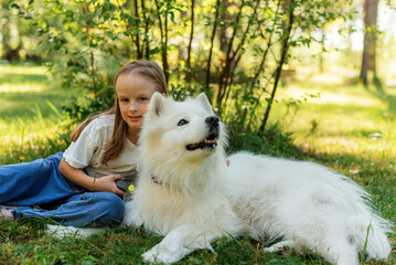Little Girl in Forest Park Walking Playing with her Dog White Samoyed Seasonal Summer Time