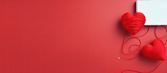 Two red yarn hearts isolated pastel background Copy space with space for text