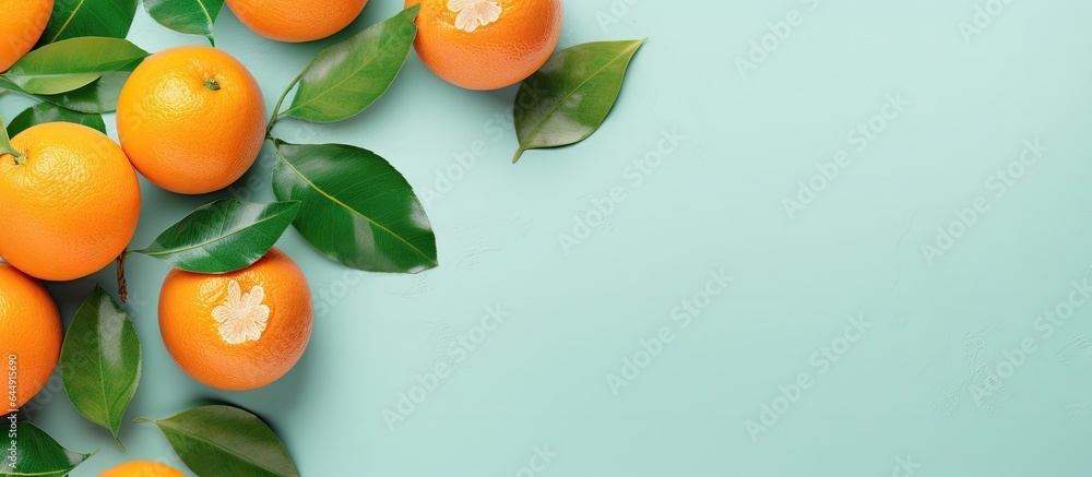 Poster Mandarin or tangerine slices with leaves on isolated pastel background Copy space Flat lay top view Fruit arrangement