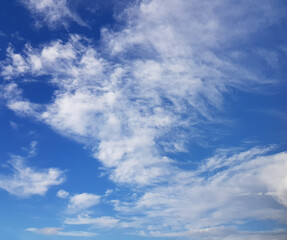 Day sky with white clouds on blue