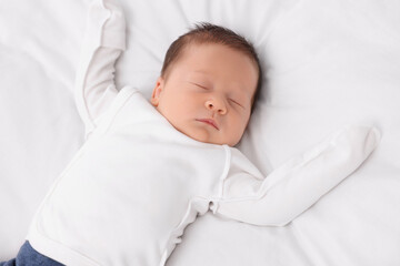Cute newborn baby sleeping on white blanket