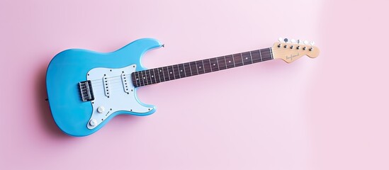 Blue guitar against isolated pastel background Copy space - obrazy, fototapety, plakaty