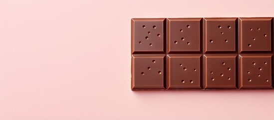 Dark chocolate bar on a isolated pastel background Copy space