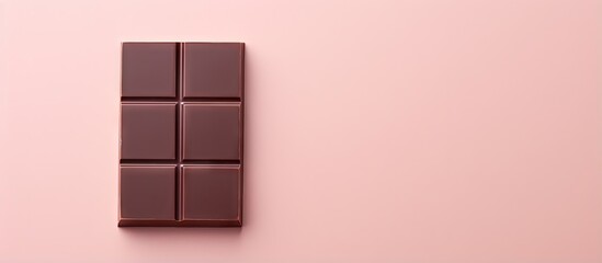 A delicious chocolate bar alone on a isolated pastel background Copy space