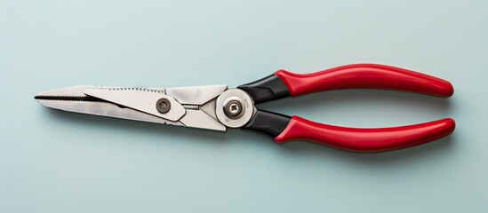 Pliers with red handle opened on a isolated pastel background Copy space