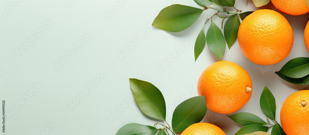Poster mandarin or tangerine slices with leaves on isolated pastel background copy space flat lay top view 
