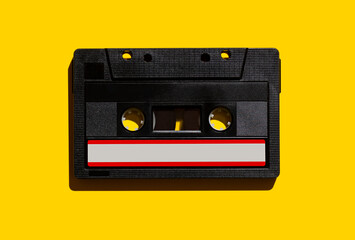 Audio cassette on a yellow background. View from above. Flat lay.