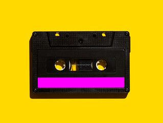 Audio cassette on a yellow background. View from above. Flat lay.