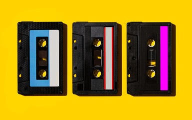 Audio cassettes on a yellow background. View from above. Flat lay.