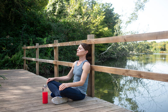 Fit, Sporty Woman Sitting Taking A Break From Exercise And Running