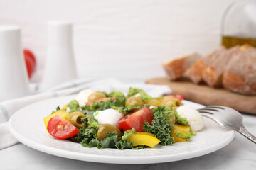 Delicious salad with pesto sauce and fork on white table, closeup