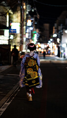 japanese geisha walking down busy night road
