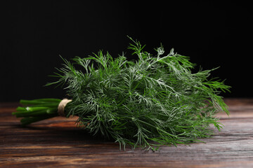 Bunch of fresh dill on wooden table, closeup