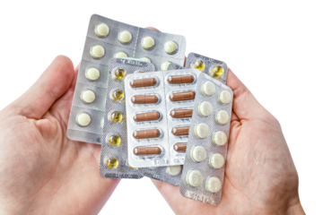 Lot of tablets in hands of the patient isolated on transparent png background. Medicine