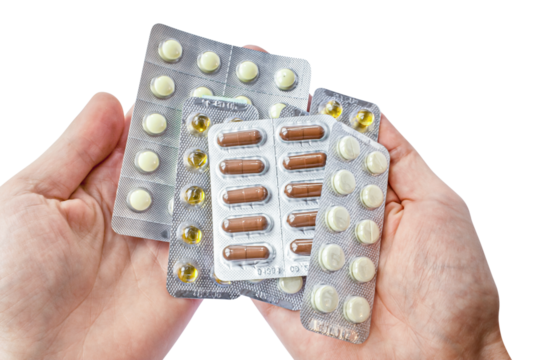 Lot of tablets in hands of the patient isolated on transparent png background. Medicine