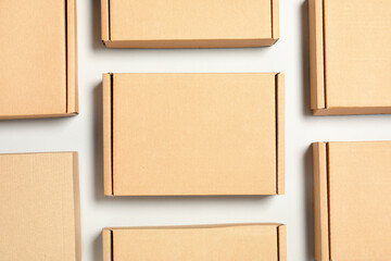 Many cardboard boxes on white background, flat lay. Packaging goods