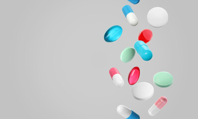 Many different colorful pills falling on light grey background, space for text