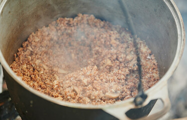 Hiking pot, Bowler in the bonfire. Fish soup boils in cauldron at the stake. Traveling, tourism,...