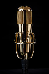 golden color microphone detail in music and sound recording studio, black background