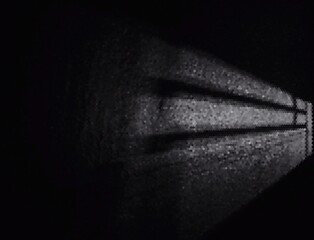 Fototapeta premium The light that escapes through the window into the bedroom at night creates a beautiful, programmable decorative light that can be used as a background for work or further development.