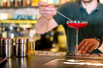 man hand bartender making cocktail in glass on the bar counter