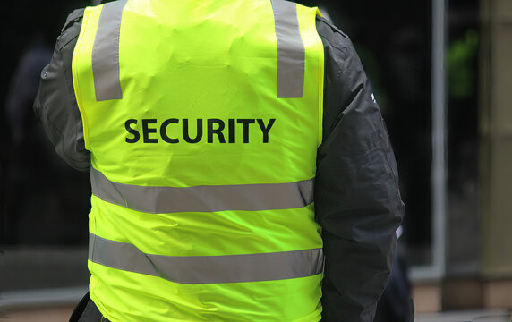 A security guard wearing a high vis vest