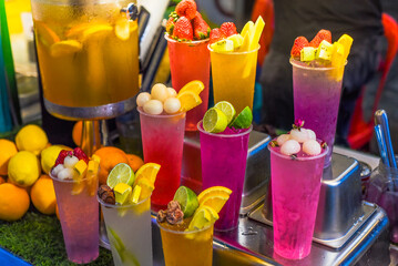 Many smoothie and drinks in plastic cups in Jalan Alor street food in the Kuala Lumpur market