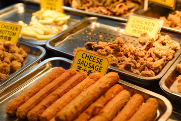 Fried cheese sausages in the street food Jalan Alor in Kuala Lumpur