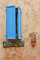 A window with blue shutters