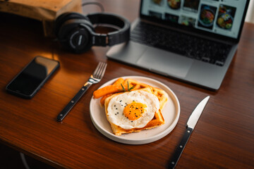 Breakfast waffles, fried eggs and sausage