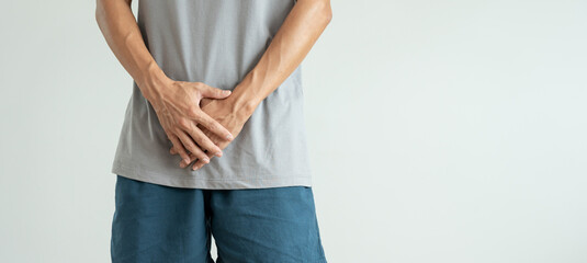 Man hold hand in front of private parts feeling discomfort from disease and inflammation. Venereal,...