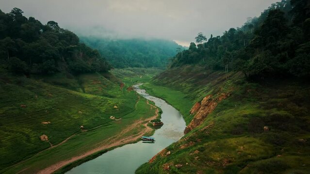 Aerial view - Beautiful greenery nature with meadow and river in Khao Chong Lom, Thailand.