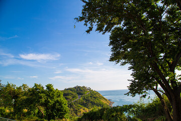 Nature seascape mountain island with beach turquoise water blue sky green tree forest