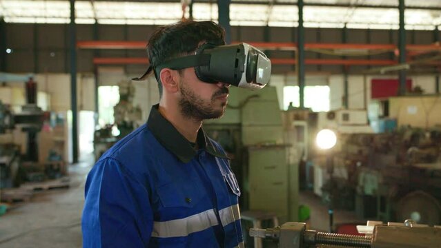 the engineer wearing VR Glasses, he look around slowly. then he shows thump up. new technology for developing production great work concepts. close up shoot.
