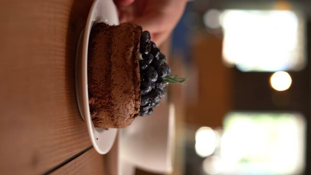 Berry dessert and coffee served on the table in a cafe or restaurant, close-up